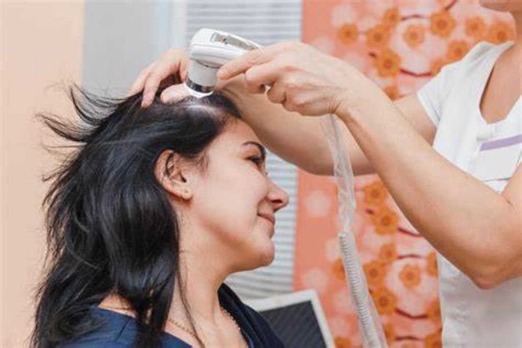 Woman undergoing Anti Hair Fall Treatment at Glam Aesthetics beauty clinic, Hyderabad